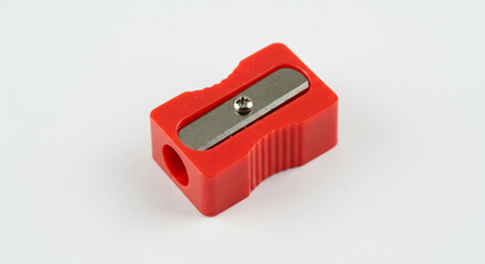 Top view of red plastic pencil sharpener isolated on white