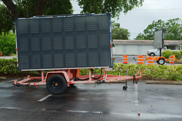 Portable Road Sign Trailer With Industrial Display Board in Urban Setting. Mobile road sign display...