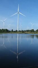 Aerial view of powerful Wind turbine farm for energy production on beautiful cloudy sky at...