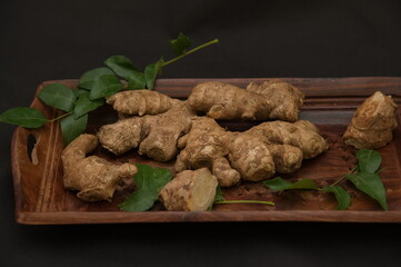 Overhead of ginger, ginger isolated background. on wooden bowl. natural fresh ginger. sliced ginger.