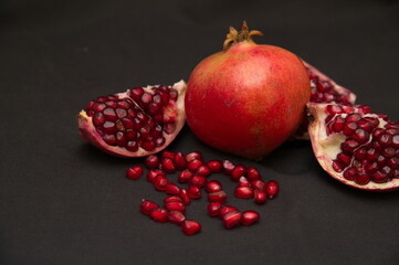 Group of pomegranates, Fresh ripe pomegranate seeds with cut in half, Delicious red ripe juicy pomegranate seed, Artistic Close up Macro, Tropical open Pomegranate with seeds.