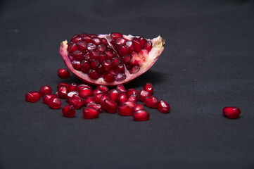 Group of pomegranates, Fresh ripe pomegranate seeds with cut in half, Delicious red ripe juicy pomegranate seed, Artistic Close up Macro, Tropical open Pomegranate with seeds.