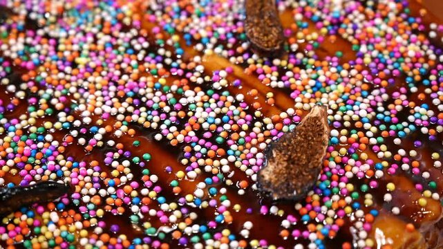 Turron covered in colorful sprinkles and topped with dried figs