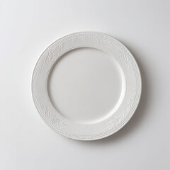 Elegant white plate with intricate design, centered on a minimalist background, ideal for dining presentations