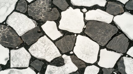 Obraz premium Abstract Stone Mosaic: Black, White, and Gray Textured Surface Composition.