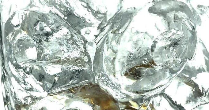 High-quality video with several ice cubes spinning in circles in the foreground