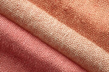 A close-up shot of three different textured fabrics, each in a different shade of pink. The fabrics are neatly folded and arranged, showcasing their details