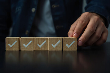Work Progress Loading Bar with Checklist. Man places a wooden block with a checkmark into a loading bar with 5 checkboxes, symbolizing progress, task completion, and project workflow development.