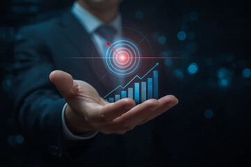 Business goal setting and success strategy. Businessman with glowing target with financial growth indicators, emphasizing leadership, data-driven decision making, and success