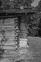 Snodgrass cabin in Chickamauga Battlefield, highlighting the chimney made of notched and chinked...