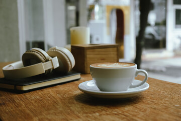 Close-up shot of a creamy latte in a white ceramic mug, evoking the warmth, comfort, relaxation and quiet enjoyment of a quiet and mindful coffee break.