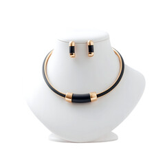 Displayed is a stylish black and gold necklace and earrings set on a mannequin against a dark backdrop, perfect for fashion advertising, transparent background