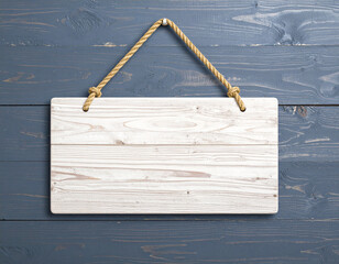 Blank white wooden sign hanging on a weathered dark blue wooden background