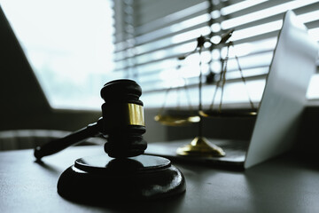 A symbolic image representing law and justice, featuring a gavel and scales, reflecting authority,...