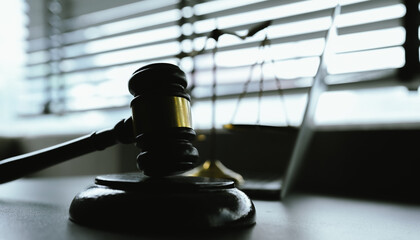 A symbolic image representing law and justice, featuring a gavel and scales, reflecting authority,...
