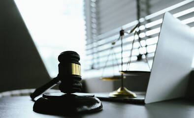 A symbolic image representing law and justice, featuring a gavel and scales, reflecting authority,...
