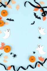 Fototapeta premium Festive halloween decorations with pumpkins ghosts bats and autumn leaves