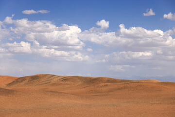desert landscape with blue sky and clouds