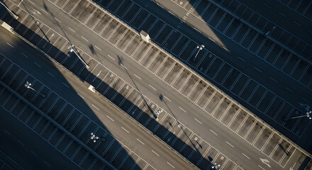 Obraz premium Aerial View Of A Vast Empty Parking Lot With Geometric Lines And Shadows