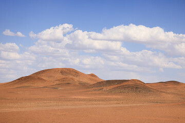 desert landscape with blue sky and clouds
