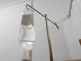 IV infusion set on pole against white background in the patient room at the hospital 