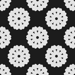 White abstract floral pattern on black background, seamless repeating design.