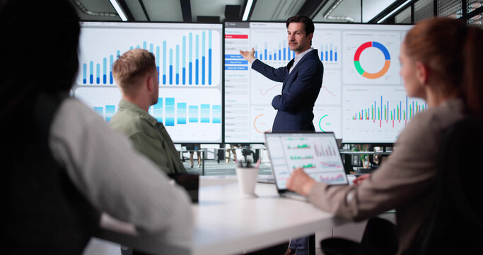 Business Team Meeting To Analyze Data In Office