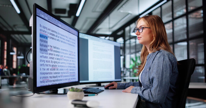 Young Woman Proofreading Book Review Article On Computer Screen