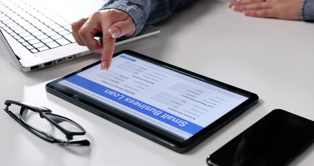 Woman Filling Out Small Business Loan Application