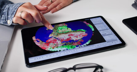 Female Scientist Tracking Hurricane Consequences On Tablet