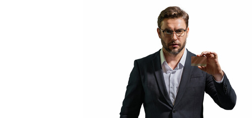 Portrait of businessman showing plastic credit card against grey background. Copyspace blank area...