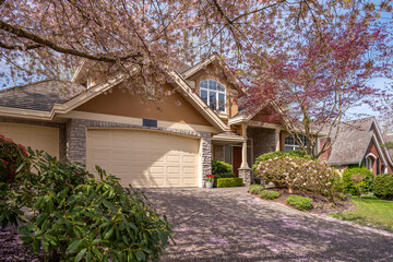 Garage door in luxury house with trees and nice landscape in Spring in Vancouver, Canada, North...