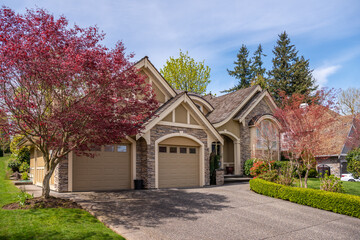 Garage door in luxury house with trees and nice landscape in Spring in Vancouver, Canada, North...