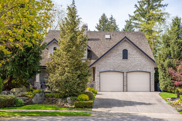 Garage door in luxury house with trees and nice landscape in Spring in Vancouver, Canada, North...