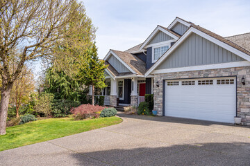 Garage door in luxury house with trees and nice landscape in Spring in Vancouver, Canada, North...