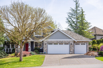 Garage door in luxury house with trees and nice landscape in Spring in Vancouver, Canada, North...