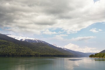 River and snowcapped mountains against cloudy sky