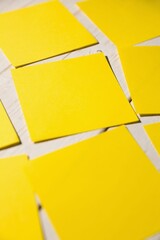 Yellow papers fallen on wooden floor