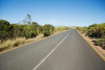 Road by trees against clear sky