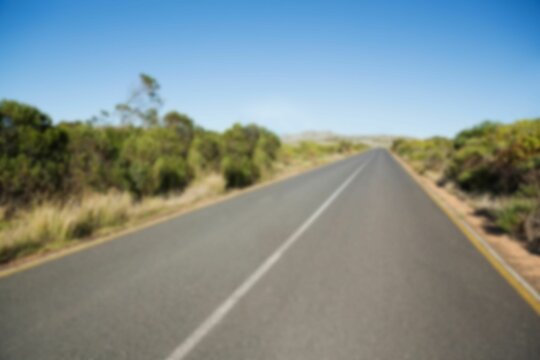 Fototapeta Road by trees against clear sky