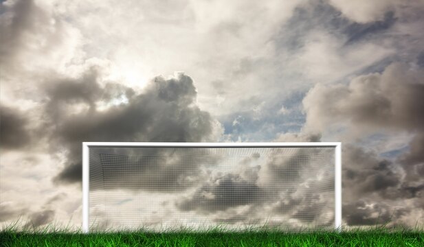 Fototapeta Football goal under grey cloudy sky