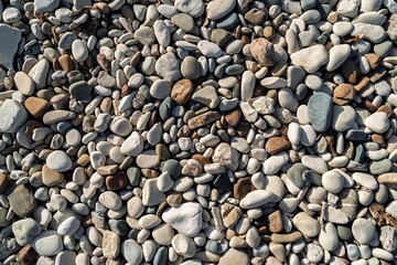 Explore the serene beauty of a pebble beach, where smooth stones form a natural mosaic. This image showcases subtle color variations, perfect for conveying peace and nature in design.