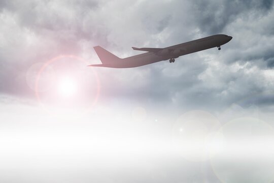 Fototapeta Airplane flying over clouds