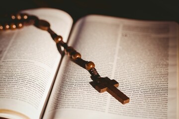 Open bible with rosary beads and cross