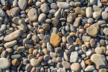 A closeup of a diverse collection of smooth beach stones. This image captures natural beauty and tranquility, making it ideal for backgrounds, textures, and creative projects.