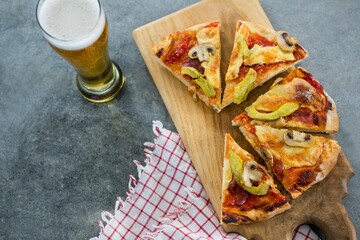 Pizza slices with beer glass on table
