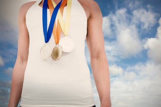 Fototapeta Midsection of female athlete against sky