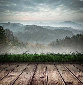 Fototapeta Mountain scene over wooden planks