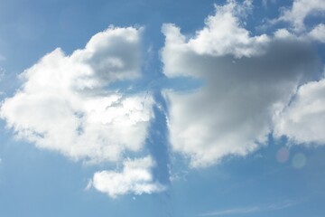 Fototapeta premium Pair of large cumulus clouds are drifting in flat vector illustration, featuring lens flare disc