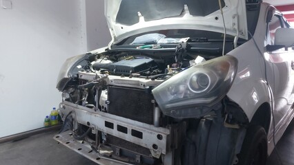 Vehicle repair showing bumper replacement, air filter service, engine components, piston and gasket...